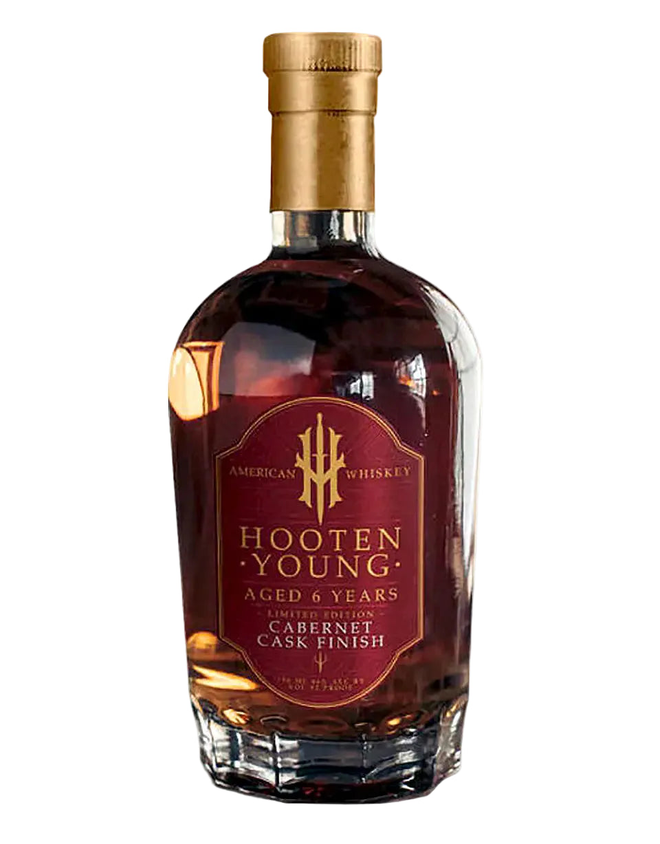 Hooten Young whiskey bottle with gold cap on a white background